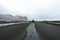 Hiker with hiking gear standing on a sand dune and celebrates the beauty of Stokksnes peninsula and Vestrahorn mountain chain