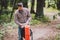 Hiker holding his camping backpack. traveler opening backpack while traveling in beautiful wood. Theme hiking and travel. Man