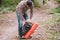 Hiker holding his camping backpack. traveler opening backpack while traveling in beautiful wood. Theme hiking and travel. Man