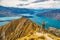 Hiker jumping of joy funny - man hiking in New Zealand. Roys Peak, South Island, New Zealand