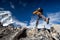 Hiker jumps on the rock near Everest in Nepal