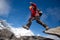 Hiker jumps on the rock near Everest in Nepal