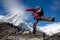 Hiker jumps on the rock near Everest in Nepal