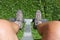 Hiker legs and shoes on a mountain chair lift in summer season