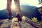 Hiker legs stand on mountain peak rock