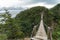 Hiker on Long Suspension Bridge