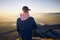 Hiker looking at mountain range at sunrise