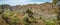 Hiker makes landscape shots of agriculture terraces, monumental mountain peaks and vast green valleys. Corda Coculli