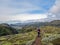 Hiker man alone into the wild admiring volcanic landscape of green Icelandic valley. Laugavegur hiking trail, summer vacations