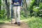Hiker man with backpack and trekking pole walking