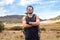 Hiker man in black sportswear with crossed arms and confident gaze in the warm savanna of Chirripo National Park in Costa Rica