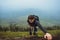 Hiker man climbing a steep wall in mountain