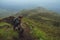 Hiker man climbing a steep wall in mountain