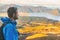 Hiker man on New Zealand trek hike tramping on outdoor trail mountain landscape. Young caucasian tramper walking with