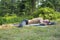 Hiker man relaxing, lying on a glade in coniferous forest and sleeping after a difficult trekking.