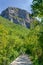 Hiker mountain landscape. Hikers with backpack climbs in mountainous path