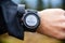 Hiker on mountain trail checking compass, wearable technology