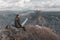 Hiker on a mountainside. Panorama of the South Ural taiga at dawn