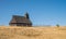 Hiker near raditional wooden church on Velika Planina