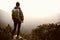 Hiker observing on mountain peak rock