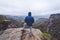 Hiker in outdoor adventure hike trail trip on the top of a mountain, enjoying view of ridge in the horizon and wild