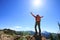 Hiker outstretched arms stand at cliff edge