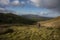 An hiker in the peat covered mountains of Wild Nephin National Park.