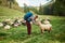 Hiker petting a sheep in the countryside