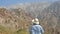 Hiker photographer taking picture of the landscape with mountains