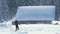 Hiker photographer taking pictures of snowy nature in winter mountains.