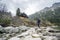 Hiker pointing to the wooden shelter in the mountains