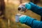 Hiker pouring hot tea from thermos into mug during trekking in forest