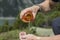 Hiker pours water from a water bottle on his hands