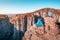 Hiker practices yoga and meditation next to her tent against the backdrop of a deep mountain gorge. Zen and fitness in