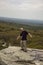 Hiker pretending to fall off Sam`s Point overlook, New York