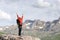 Hiker raising arms celebrating in a high mountain