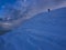 Hiker reaching the summit of mount Catria in winter at sunset, Umbria, Apennines, Italy