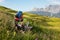 Hiker refilling his water bottle at a spring in the Dolomite mountains