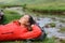 Hiker resting in a riverside