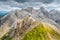 Hiker on the ridge of Dolomites Mountains in Alps, Italy. Via ferrata trail. Peole on the rocky mountains path. Travel in Dolomite