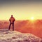 Hiker on rock above valley enjoing freedom and amazing view