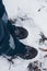 Hiker`s boots with gaiters in the winter forest. Lifestyle look from above