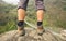 Hiker shoes on hiker legs standing above bridge