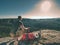 Hiker in shorts and blue singlet eat toasts for breakfast in rocks