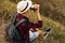 Hiker sits on the top of the mountain, man with a cup of coffee sits on a rock with a view of the nature around