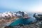 Hiker sits on the top of the mountain Ryten in Lofoten islands in Norway