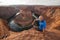 A hiker sitting at the cliff near Horseshoe bend landmark, Arizona, USA