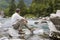 Hiker sitting at a mountain creek