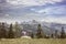 Hiker sitting on rock on a mountain top in alpine landscape