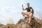 Hiker sitting on rock for resting during trekking trail on mountain
